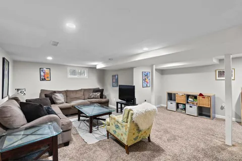 a bedroom with a large bed and a painting on the wall