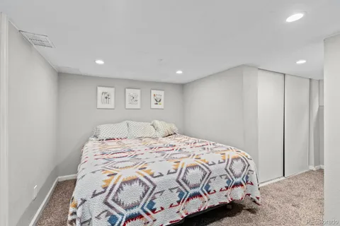 a bathroom with a granite countertop sink a mirror and a bathtub