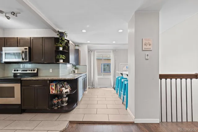 a kitchen with stainless steel appliances granite countertop a stove and a sink