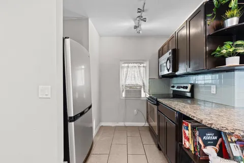 a kitchen with stainless steel appliances granite countertop a stove and a refrigerator