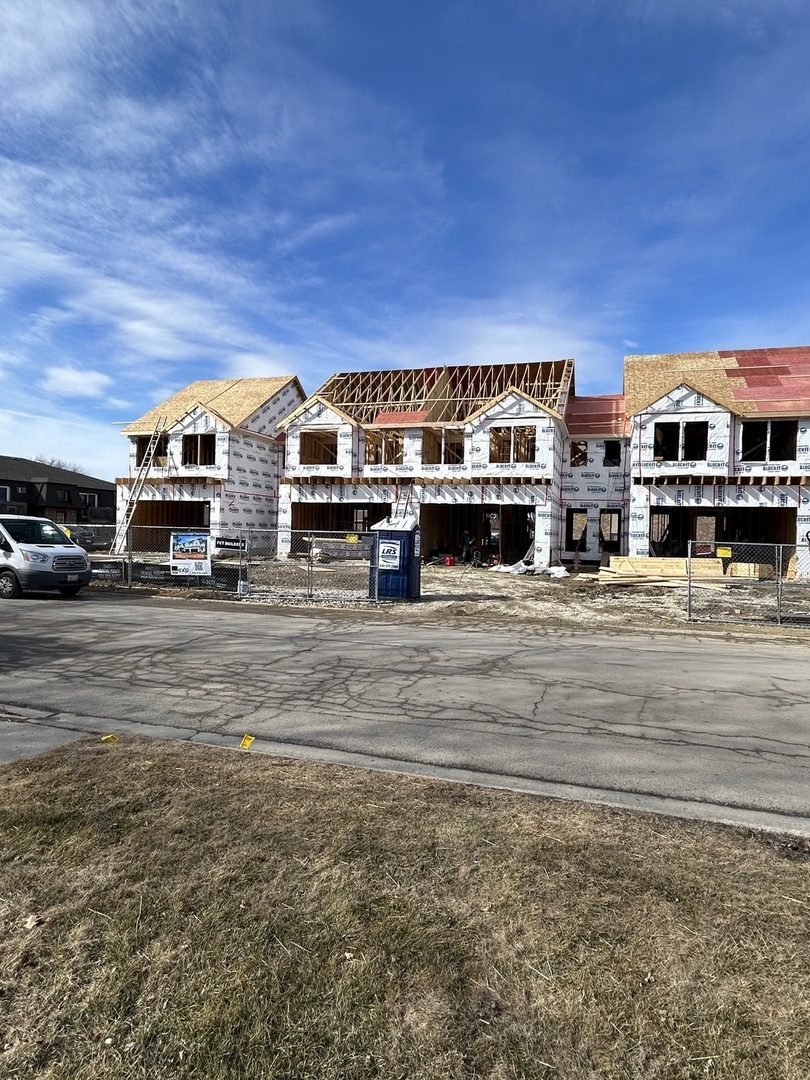 2021 Princess Court Lockport, IL 60441 - Photo 13 of 13 a front view of residential houses with yard and car parked