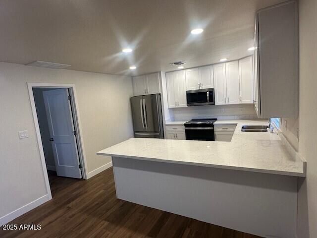 4213 East Mandan Street Phoenix, AZ 85044 - Photo 3 of 16 a kitchen with kitchen island white cabinets and refrigerator