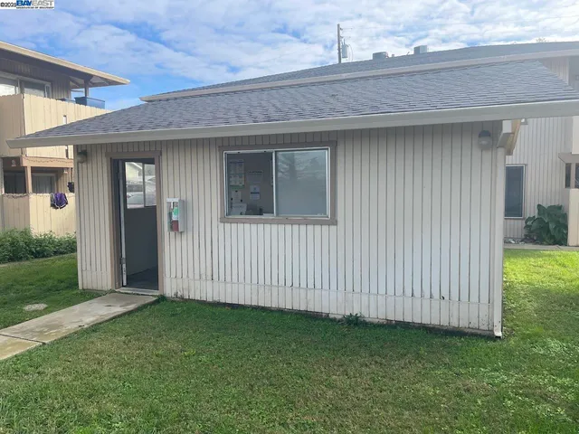 a view of a house with a backyard
