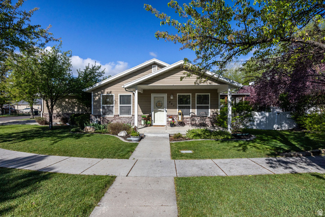 867 South 670 West Logan, UT 84321 - Photo 1 of 1 Bungalow with a porch, a front yard, and brick siding