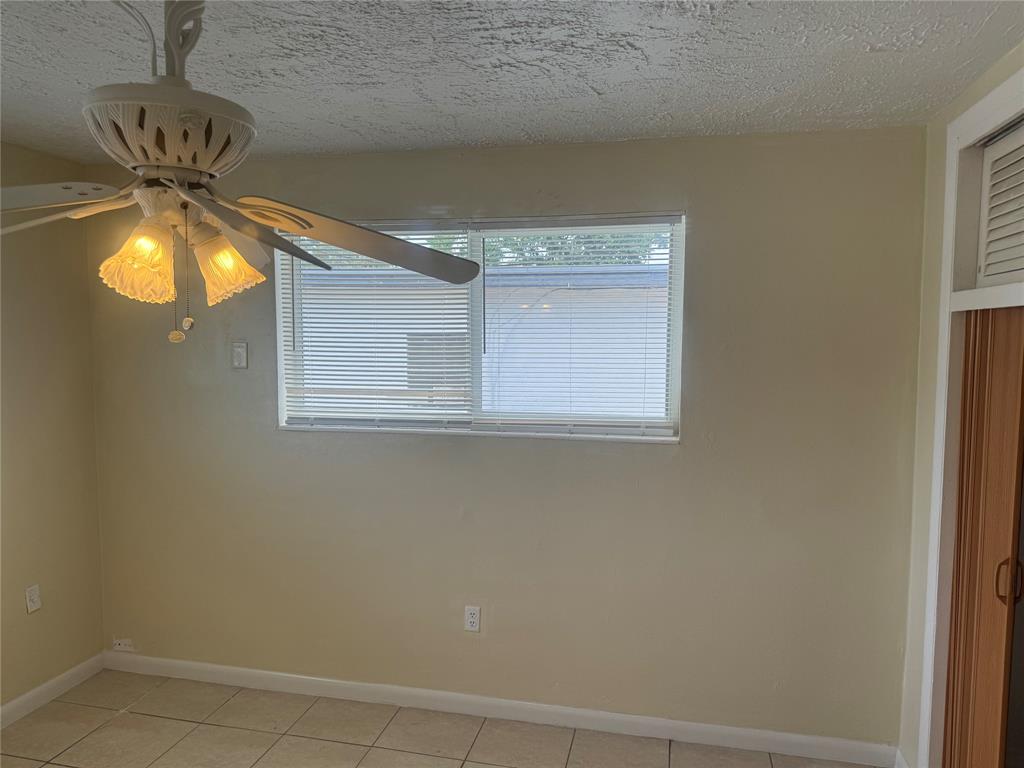 2986 Northwest 91st Street Miami, FL 33147 - Photo 11 of 40 a view of a chandelier fan and wooden floor