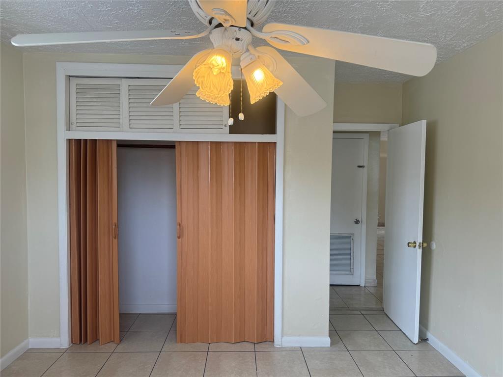 2986 Northwest 91st Street Miami, FL 33147 - Photo 12 of 40 a room that has a door and a chandelier fan