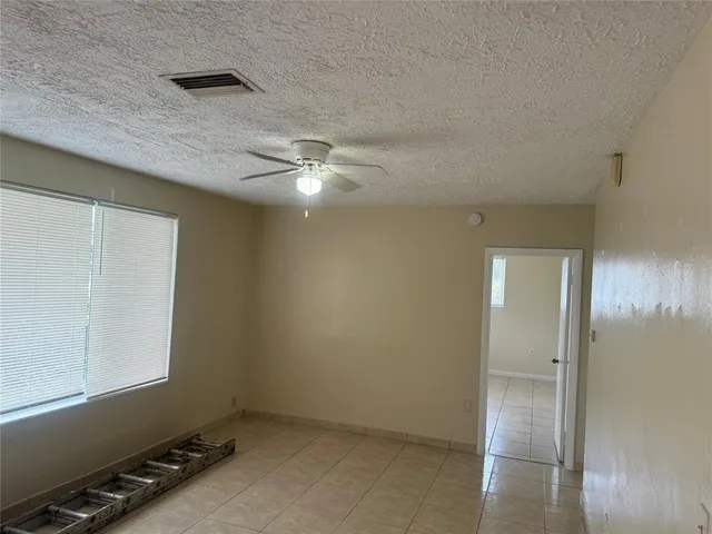 a kitchen with white cabinets and black appliances