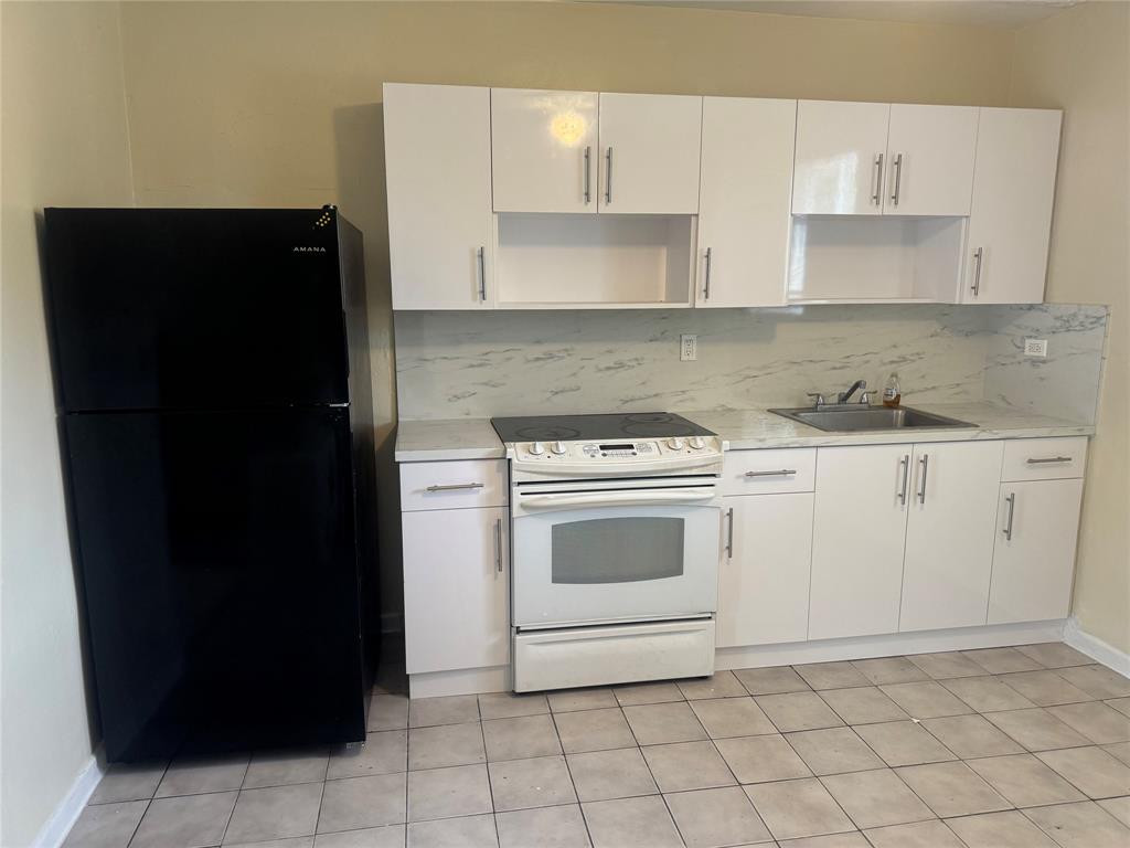 2986 Northwest 91st Street Miami, FL 33147 - Photo 17 of 40 a kitchen with a sink and a stove