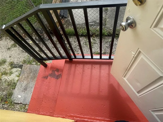 a view of a balcony with two chairs and a table