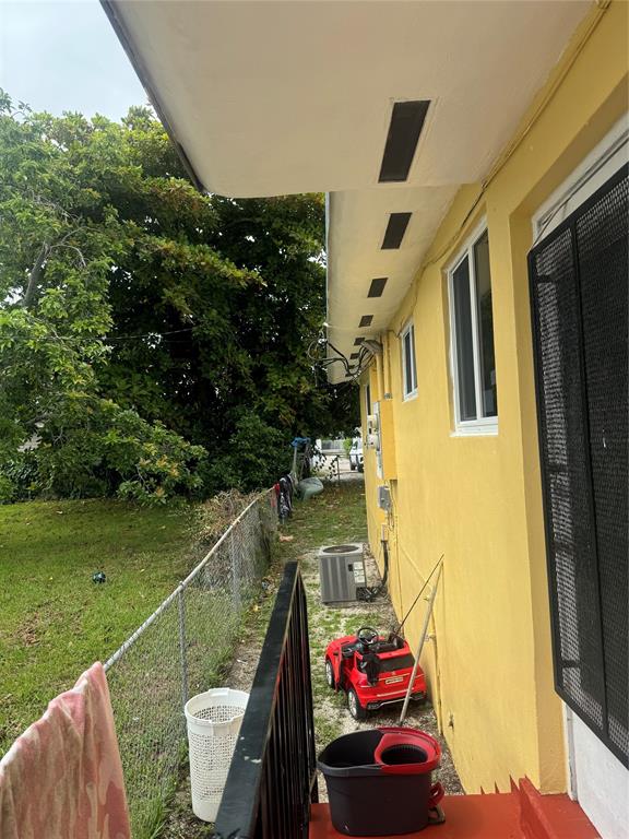 2986 Northwest 91st Street Miami, FL 33147 - Photo 24 of 40 a view of a balcony with two chairs and a table
