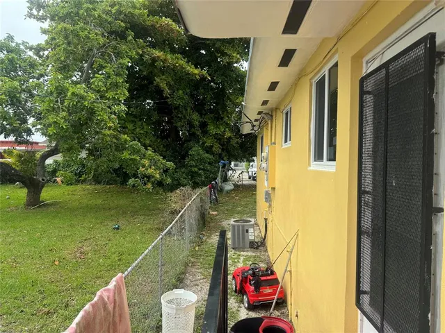 a backyard of a house with table and chairs