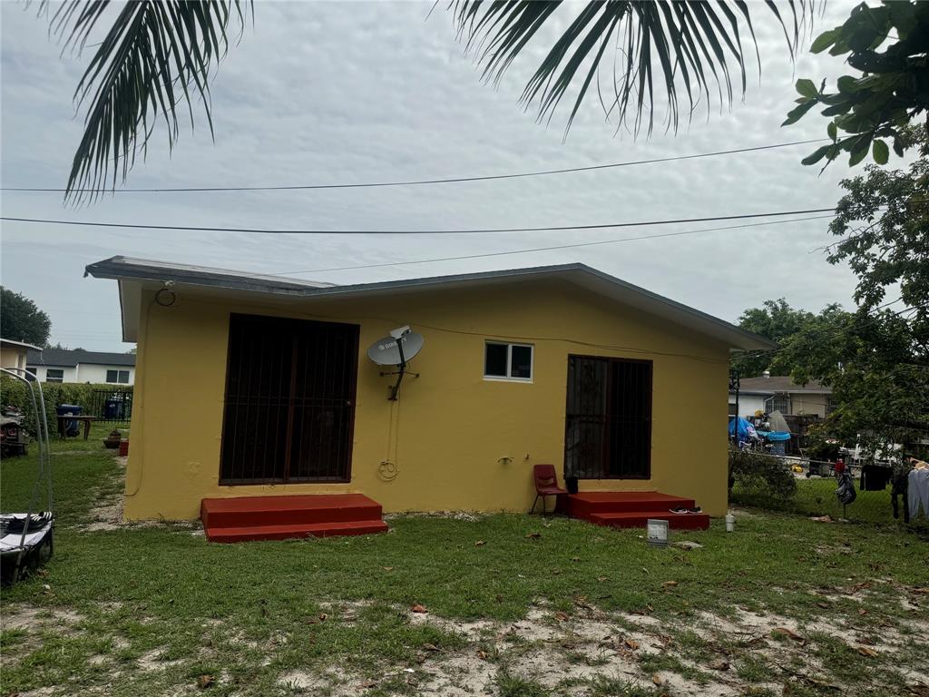 2986 Northwest 91st Street Miami, FL 33147 - Photo 31 of 40 a front view of house with yard and seating area
