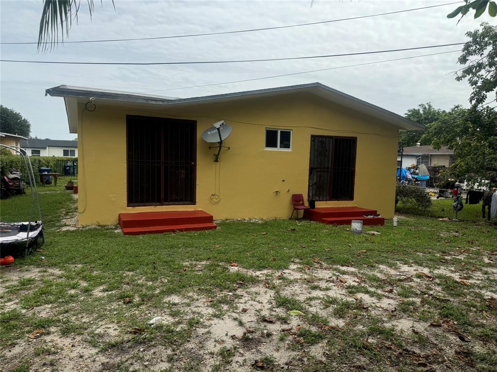 2986 Northwest 91st Street Miami, FL 33147 - Photo 32 of 40 a front view of house with yard and outdoor seating