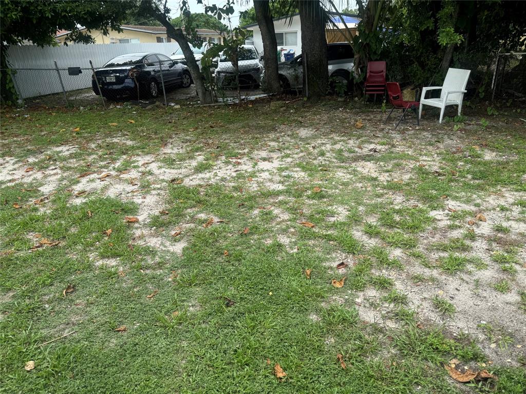 2986 Northwest 91st Street Miami, FL 33147 - Photo 36 of 40 a view of a backyard with table and chairs and a fire pit