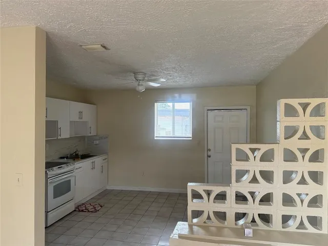 a kitchen with granite countertop a stove and a sink