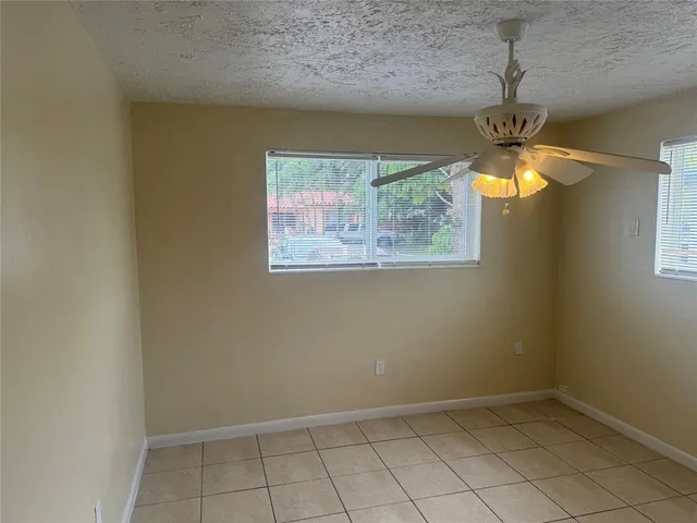 a view of a chandelier fan and wooden floor