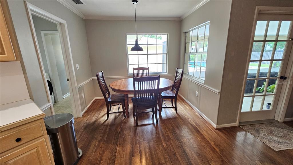 184 Lake Otis Road Winter Haven, FL 33884 - Photo 12 of 31 a view of a dining room with furniture window and wooden floor
