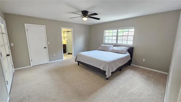 a spacious bedroom with a bed and window