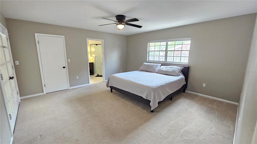 184 Lake Otis Road Winter Haven, FL 33884 - Photo 16 of 31 a spacious bedroom with a bed and window