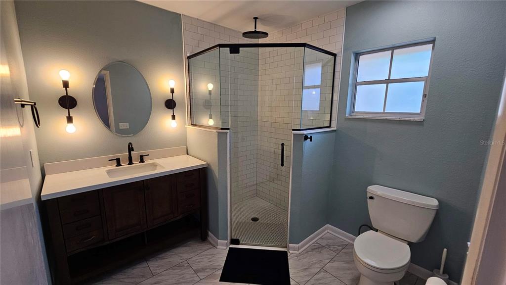 184 Lake Otis Road Winter Haven, FL 33884 - Photo 18 of 31 a bathroom with a toilet sink and mirror