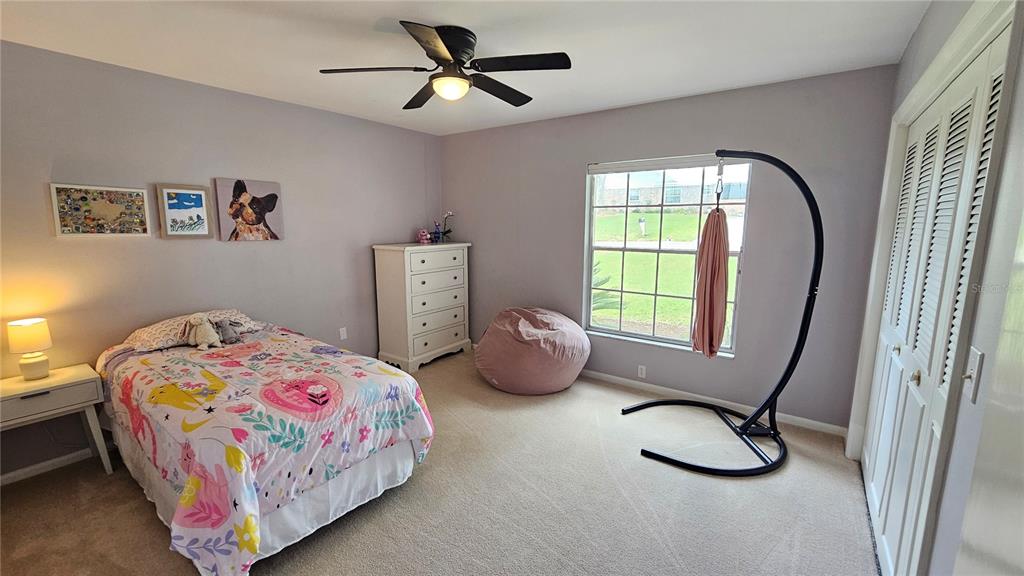 184 Lake Otis Road Winter Haven, FL 33884 - Photo 19 of 31 a bedroom with a bed a window and dresser