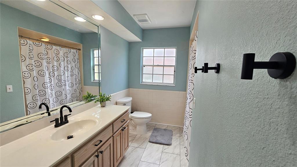 184 Lake Otis Road Winter Haven, FL 33884 - Photo 22 of 31 a bathroom with a double vanity sink toilet and shower