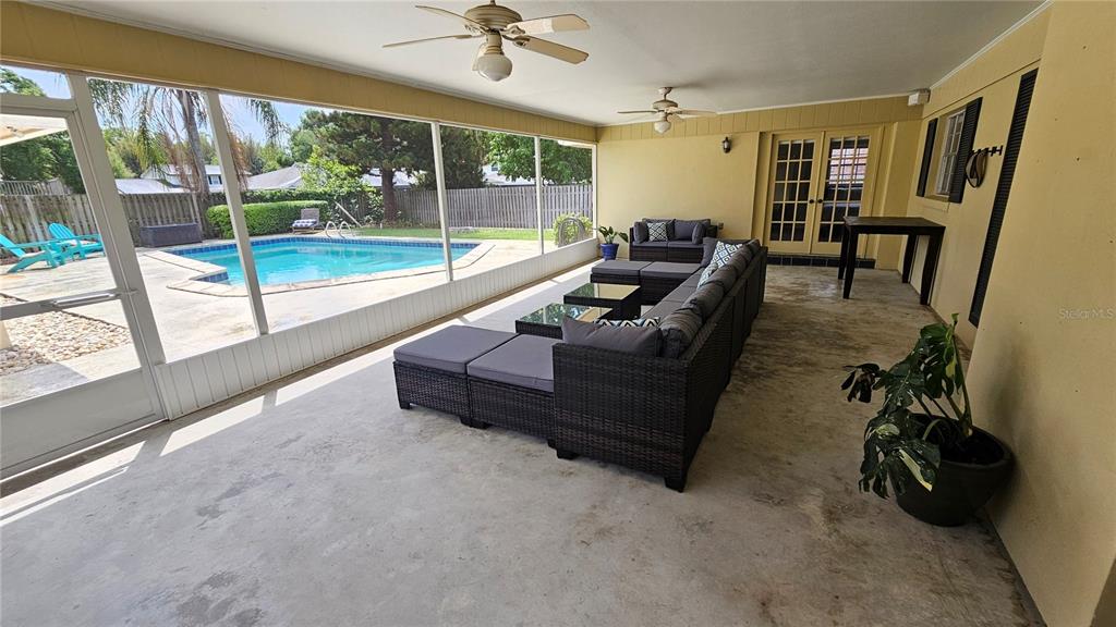 184 Lake Otis Road Winter Haven, FL 33884 - Photo 23 of 31 a living room with furniture and a floor to ceiling window
