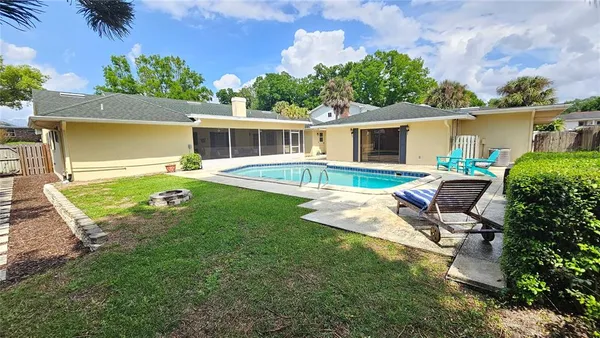 a view of a house with backyard sitting area and garden