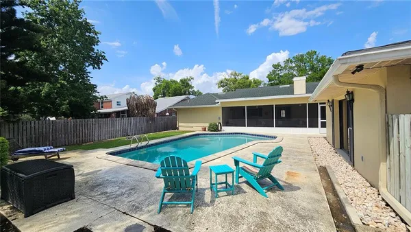 a view of a house with backyard and sitting area