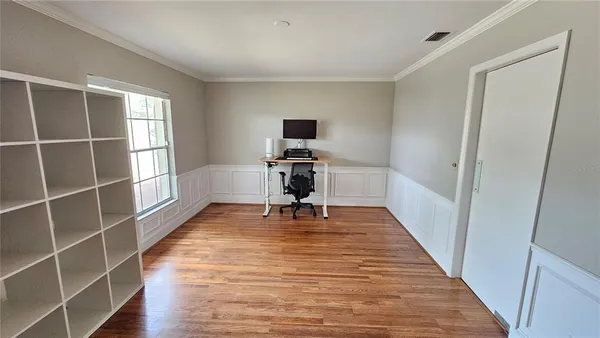 a view of a livingroom with wooden floor and a piano