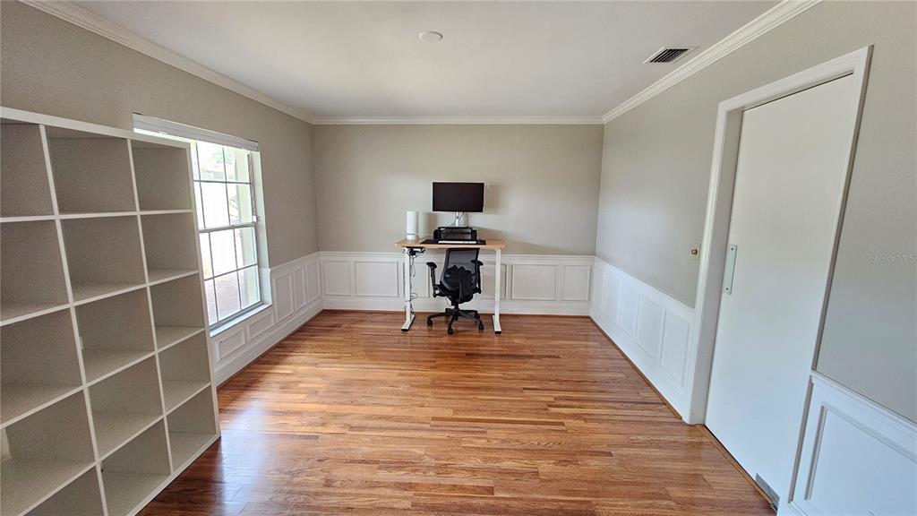 184 Lake Otis Road Winter Haven, FL 33884 - Photo 6 of 31 a view of a livingroom with wooden floor and a piano