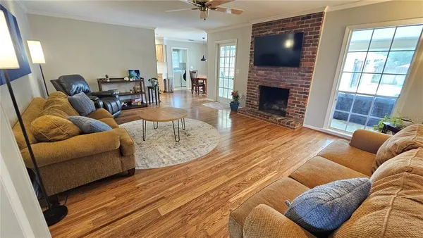 a living room with furniture fireplace and a flat screen tv