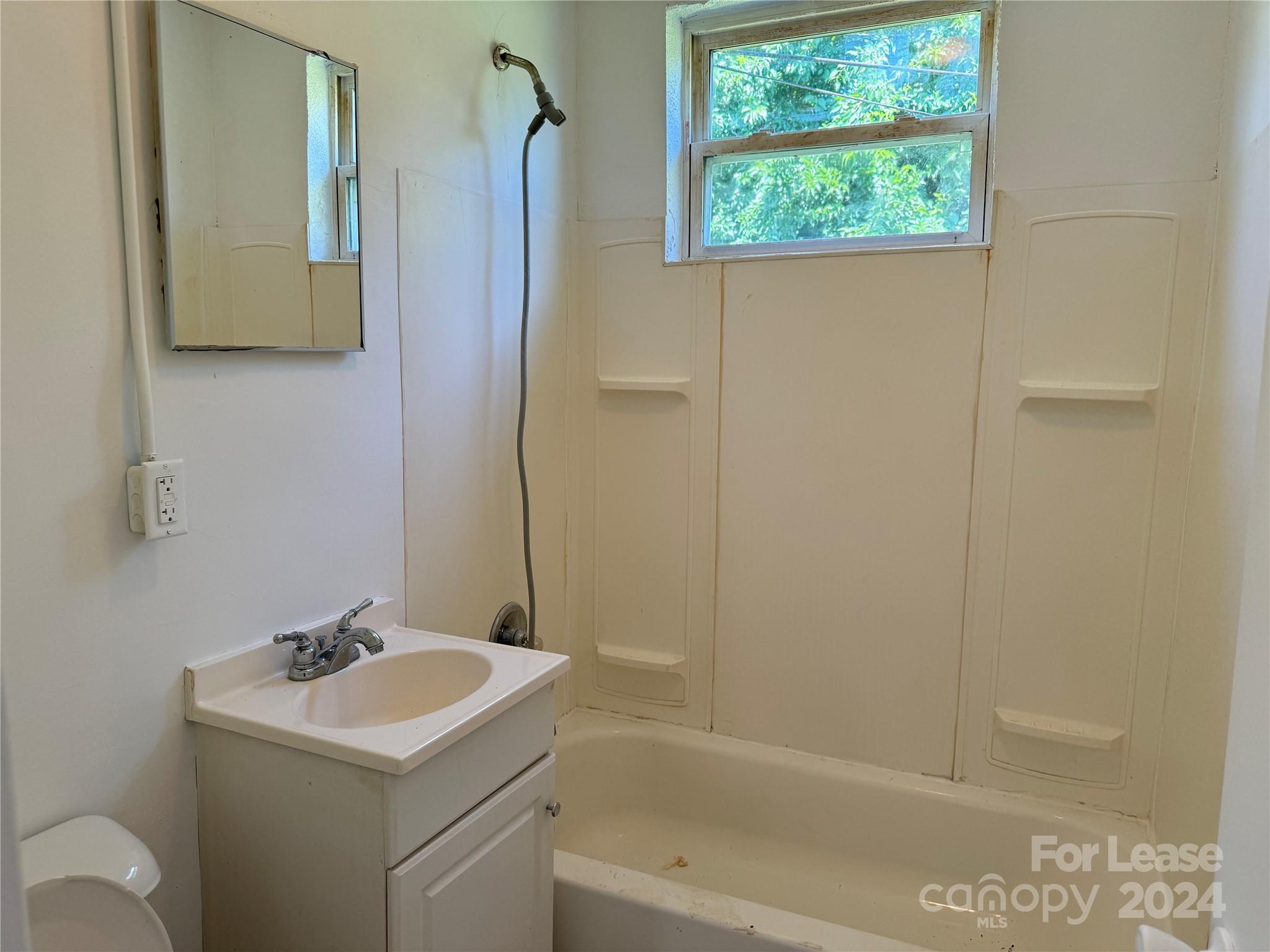 200 York Street, Unit E2 Chester, SC 29706 - Photo 11 of 15 a bathroom with a sink a toilet and shower