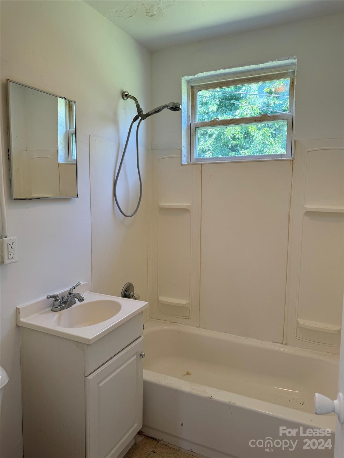 200 York Street, Unit E2 Chester, SC 29706 - Photo 12 of 15 a bathroom with a bath tub a sink and a window
