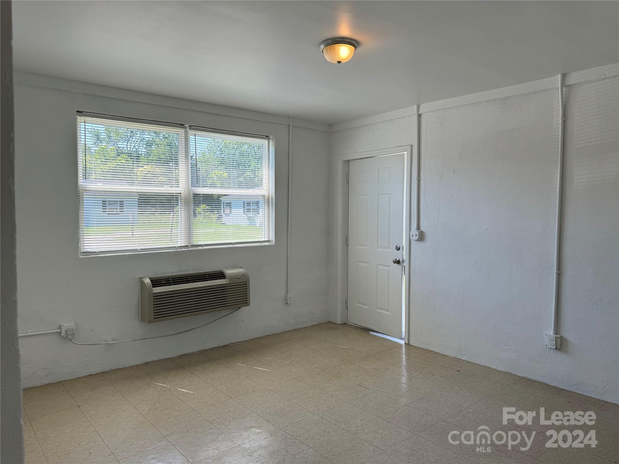 200 York Street, Unit E2 Chester, SC 29706 - Photo 5 of 15 an empty room with furniture and windows