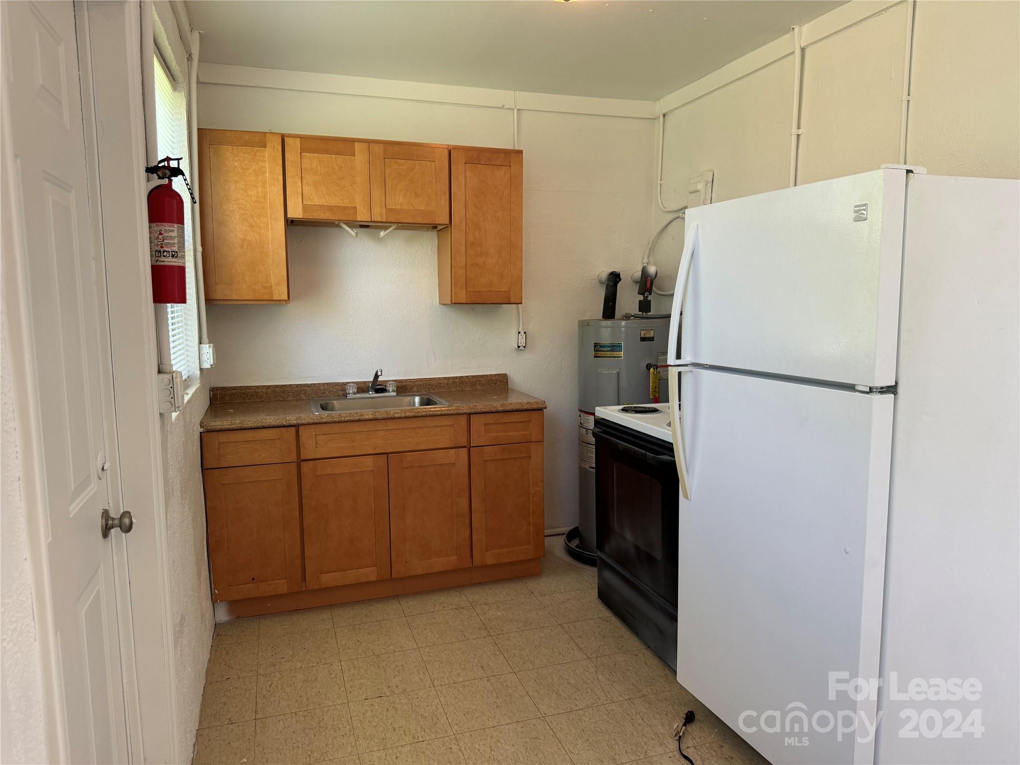 200 York Street, Unit E2 Chester, SC 29706 - Photo 6 of 15 a kitchen with a refrigerator and a sink