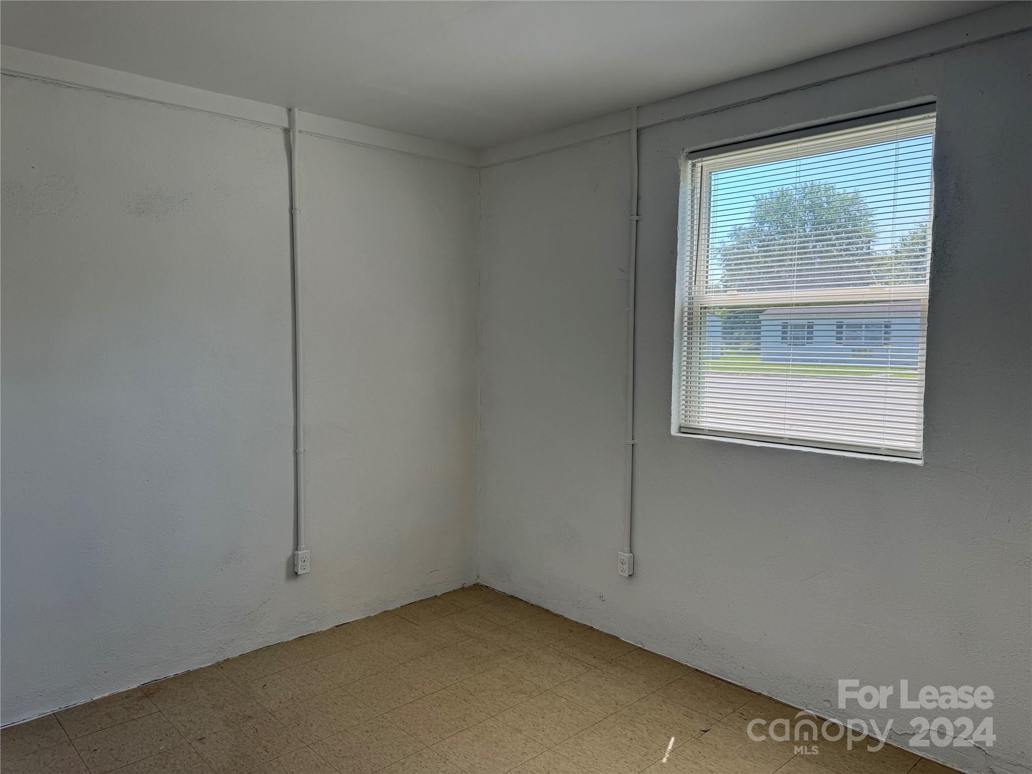 200 York Street, Unit E2 Chester, SC 29706 - Photo 8 of 15 a view of an empty room with a window