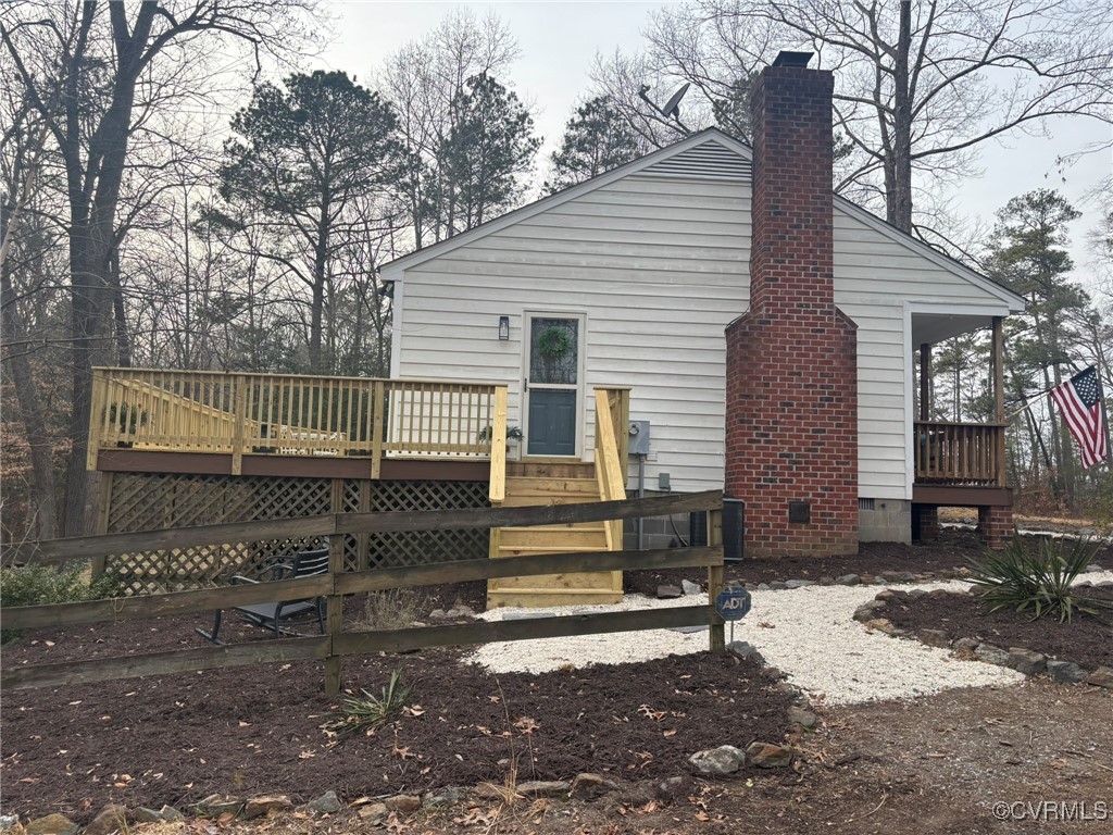 Rear view of house featuring a deck