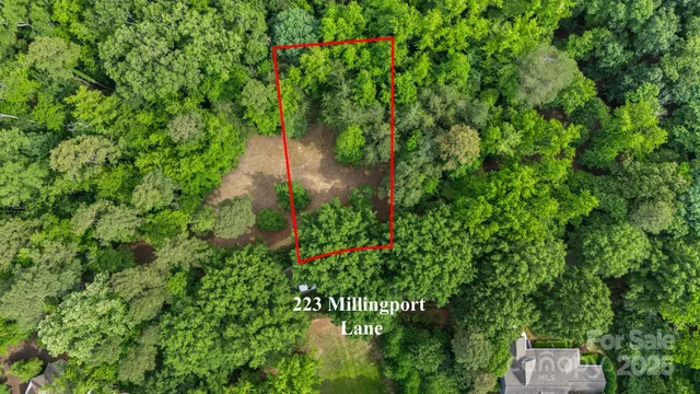 a backyard of a house with lots of green space and a fountain