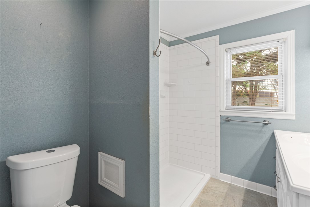 202 Keowee Trail Seneca, SC 29672 - Photo 21 of 35 This modern bathroom features a tiled shower and a window, offering natural light and a refreshing atmosphere.