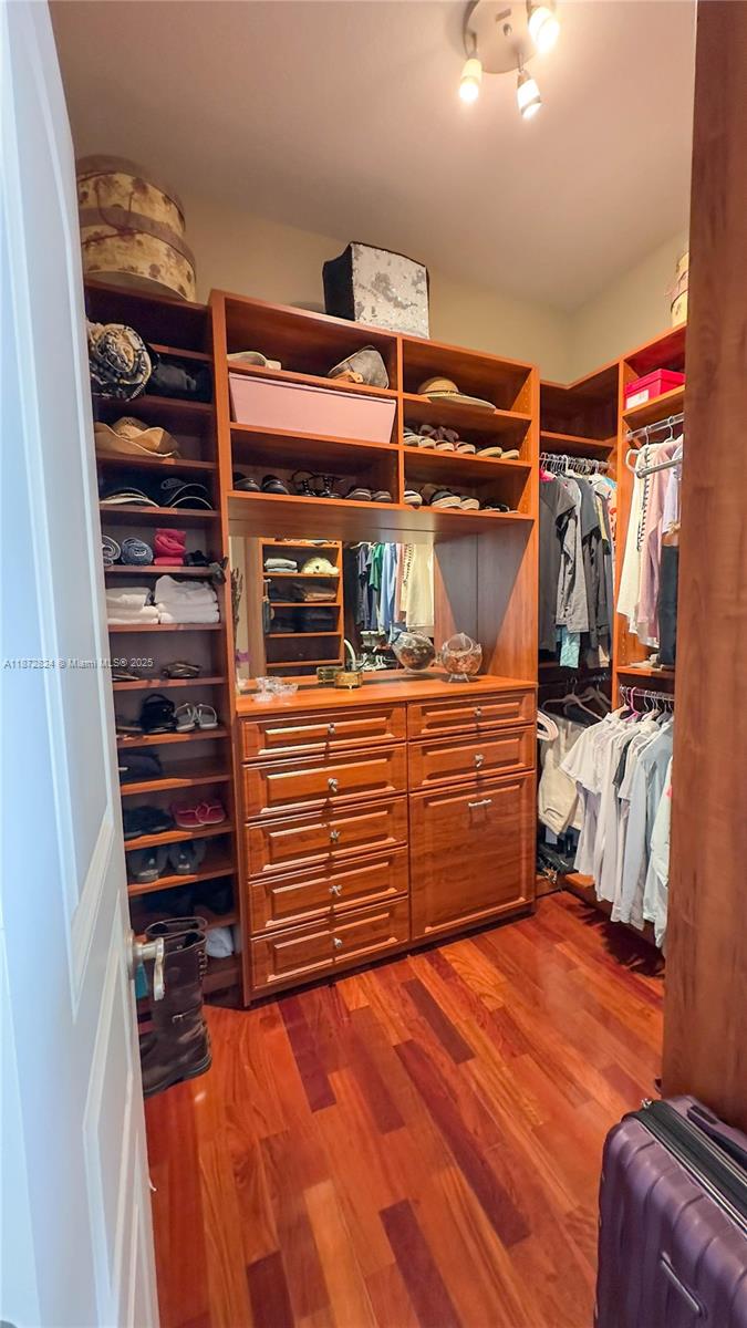 13040 Southwest 30th Court Davie, FL 33330 - Photo 23 of 42 a view of walk in closet with clothes and shoes