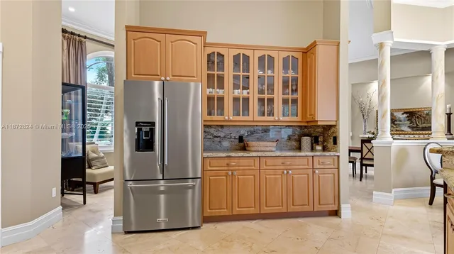 a kitchen with stainless steel appliances a refrigerator and a stove top oven