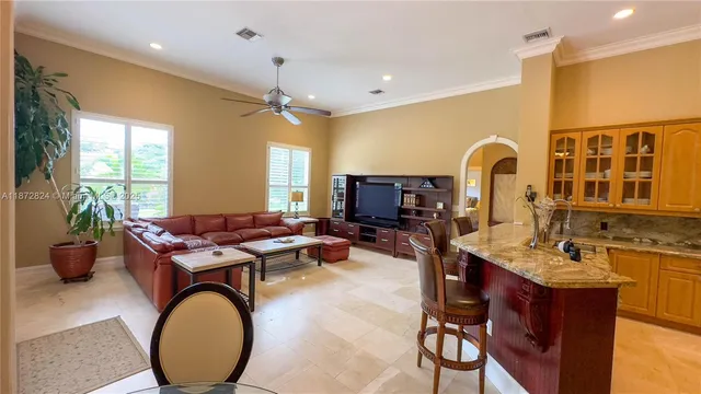 a living room with furniture a flat screen tv and a window