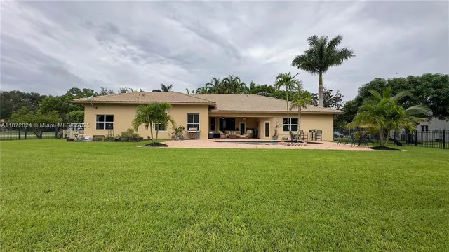 a front view of a house with a garden and yard