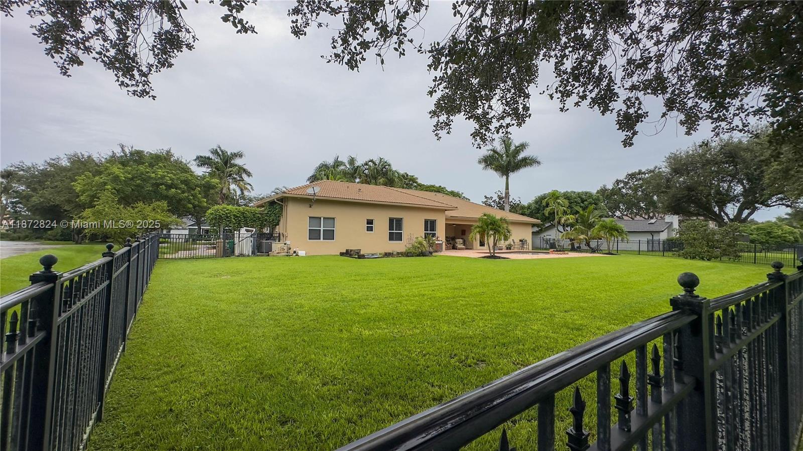 13040 Southwest 30th Court Davie, FL 33330 - Photo 39 of 42 a view of a house and a yard with wooden fence