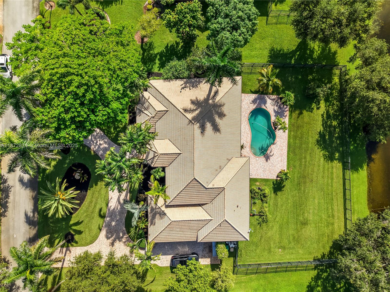 13040 Southwest 30th Court Davie, FL 33330 - Photo 5 of 42 an aerial view of a house with garden space and trees all around