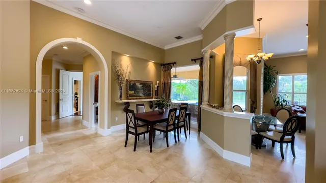 a view of a dining room with furniture and a large window