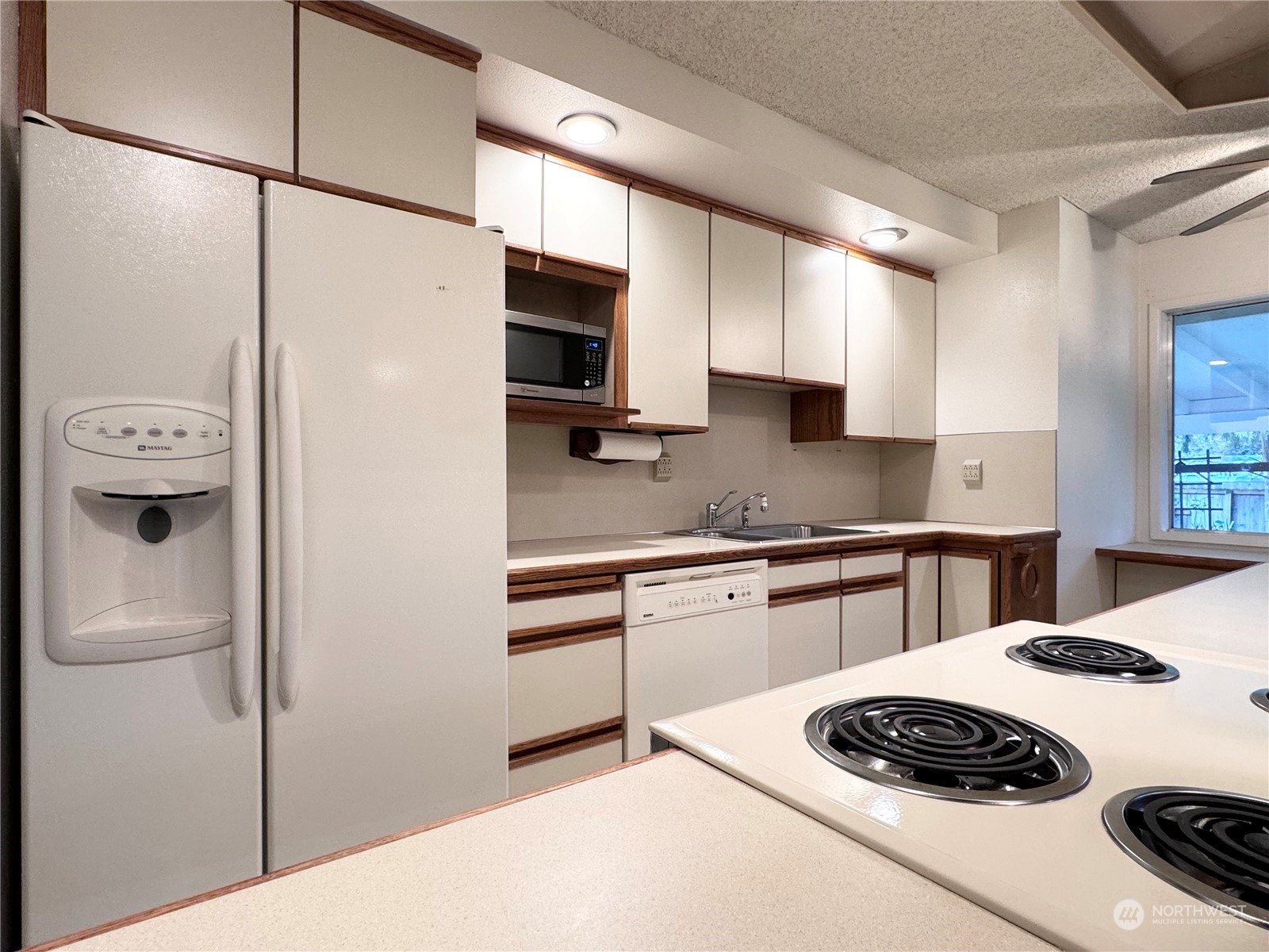 4610 Windemere Street Longview, WA 98632 - Photo 5 of 16 a kitchen with a refrigerator and a stove