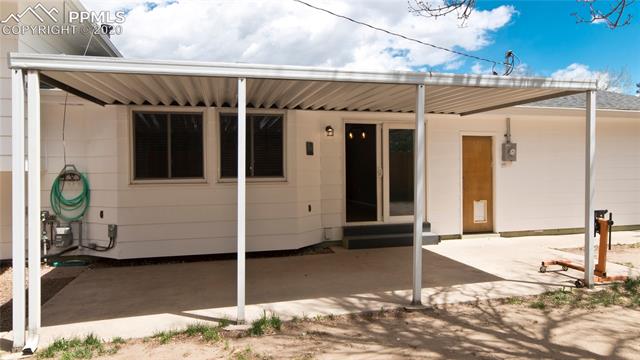 4027 Maxwell Road Colorado Springs, CO 80909 - Photo 31 of 35 Backyard patio with walk-out access from dining room, large covered area.