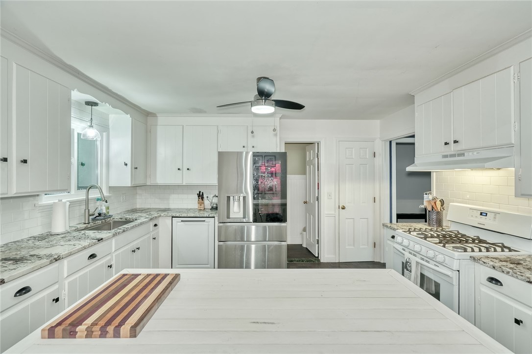 Richly patterned countertops pair with classic white cabinetry in this functional workspace.
